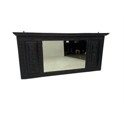 19th century Gothic revival oak overmantle or wall mirror, projecting cornice over frieze carved with half flowers and scrolls, central rectangular mirror flanked by two panels with lion head and foliate carvings