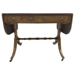 Regency mahogany sofa table, rectangular crossbanded top with twin drop-leaf ends, fitted with single drawer and one faux drawer, raised on shaped end supports united by ring turned stretcher