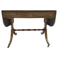  Regency mahogany sofa table, rectangular crossbanded top with twin drop-leaf ends, fitted with single drawer and one faux drawer, raised on shaped end supports united by ring turned stretcher