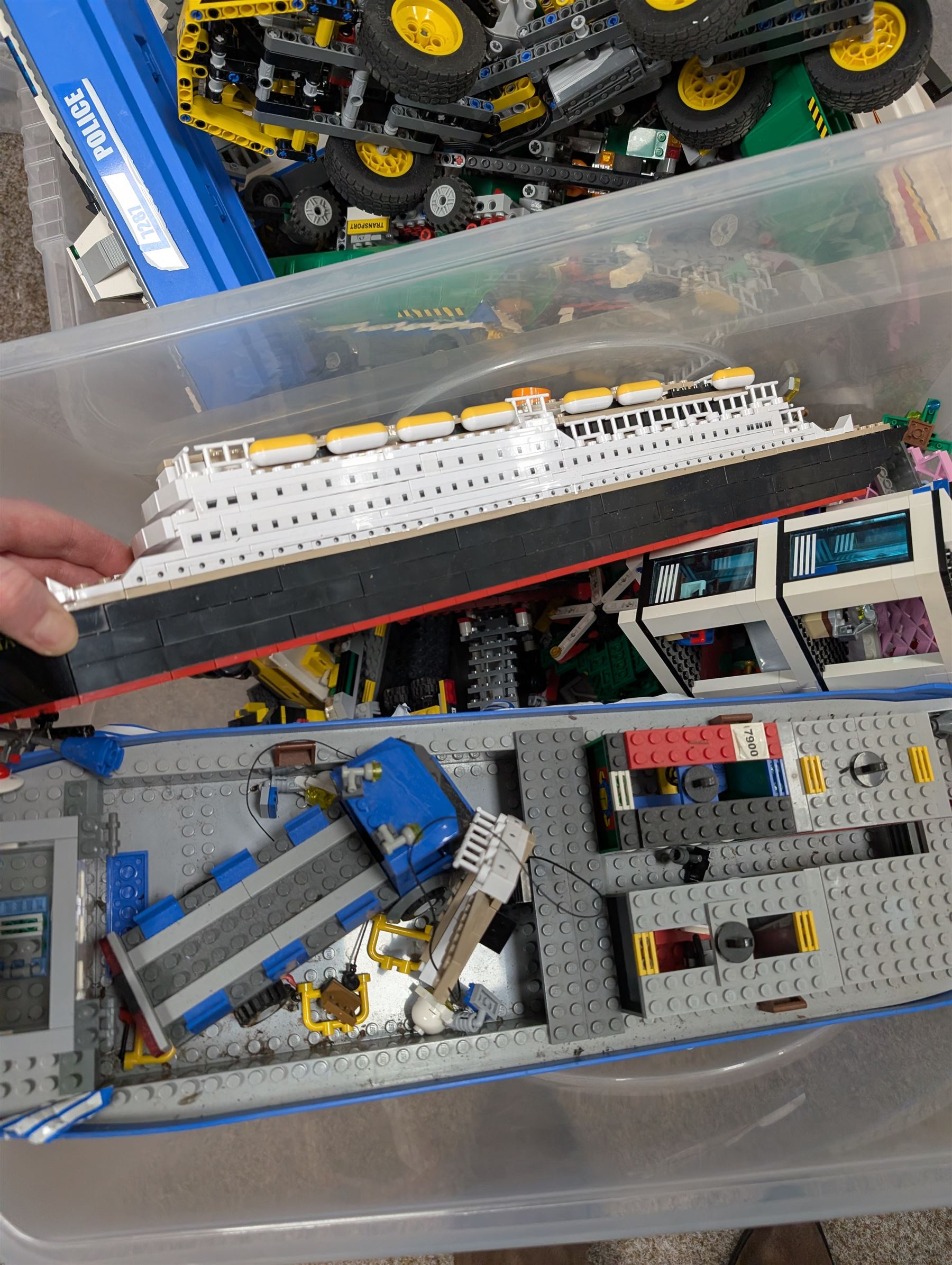 Two boxes of partially built Lego vehicles, including Lego Technics Dumper Truck no. 8264, Titanic, container ships, police boat, smaller police vehicles, etc