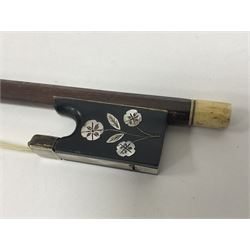 19th century wooden violin bow with a decorative mother of pearl inlay depicting flowers to the frog, with a bone adjuster screw