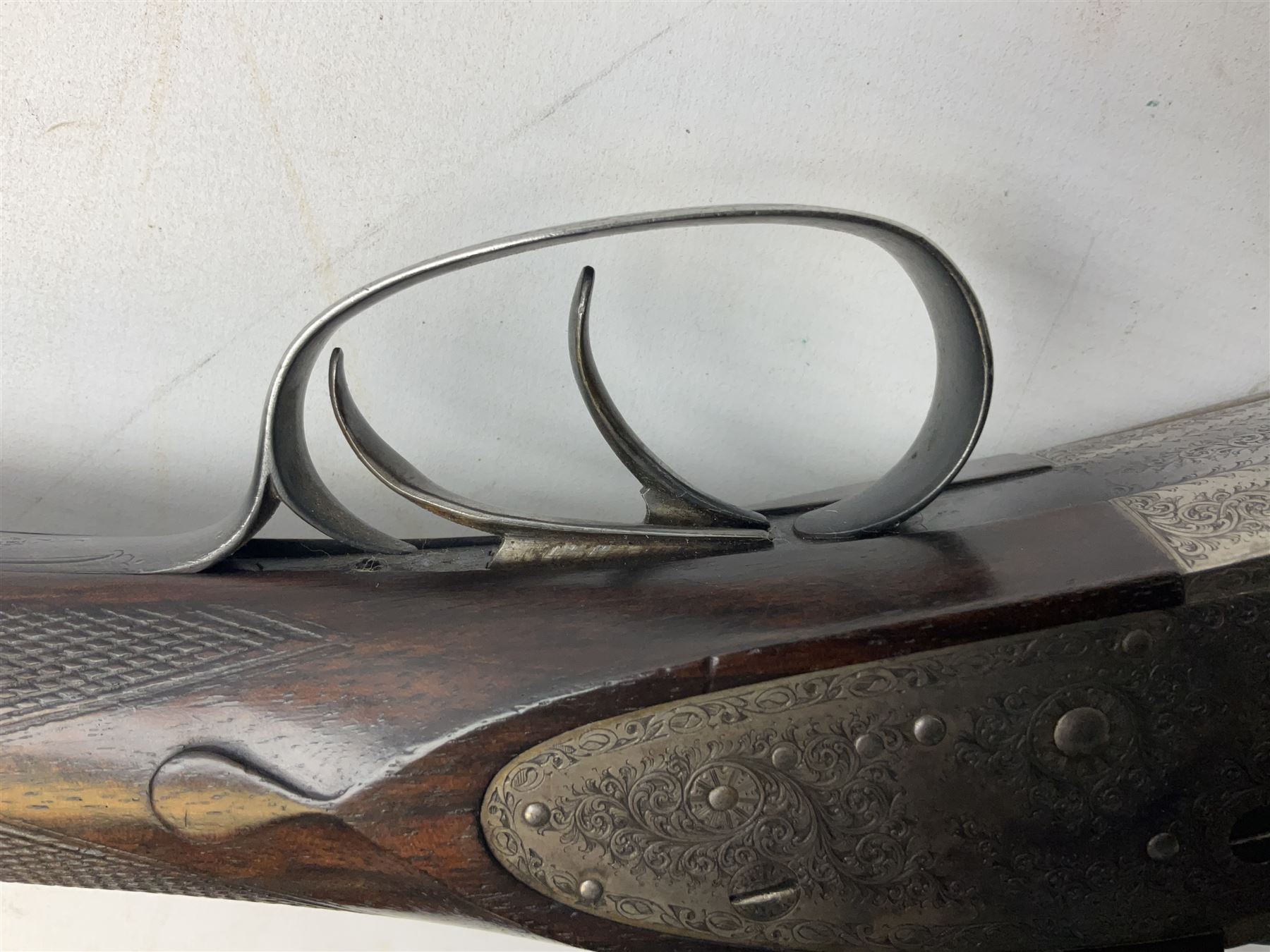 Smith Midgley Bradford 12-bore side-by-side double barrel side-lock ejector shotgun with 71cm barrels, engraved action with patented top lever, ivy leaf fences and top safety, walnut stock with chequered grip and fore-end, serial no.62409 to barrels and 1481 to action, L115cm overall SHOTGUN CERTIFICATE REQUIRED