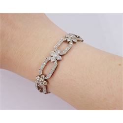 18ct white gold and platinum, milgrain set old cut diamond flower head and openwork panel link bracelet, total diamond weight approx 4.25 carat