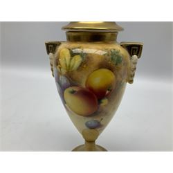 Pair of mid/late 20th century Royal Worcester vases and covers decorated by Frank Roberts, each of slender ovoid form with twin key and husk handles, and gilt covers, hand painted with a still life of fruit upon a mossy ground, signed F Roberts, upon a gilt circular pedestal foot, with black printed marks beneath including shape number 2713, H20.5cm