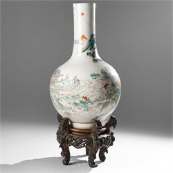 Chinese Kangxi period famille verte vase, the body finely painted with a continuous narrative scene of figures inside and out of a pavilion complex, beside a river, rocks and trees, character mark to base, raised upon a hardwood stand, overall H47cm