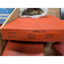 Hornby 'O' gauge 42380 No.2 Turntable, 43063 Points and 42320 No. 1 Level Crossing, all boxed, together with two tin plate passenger coaches, Hornby 'O' gauge LMS tender, three plastic 'O' gauge wagons, Hornby mechanisms, HM Duette Transformer Controller and other accessories