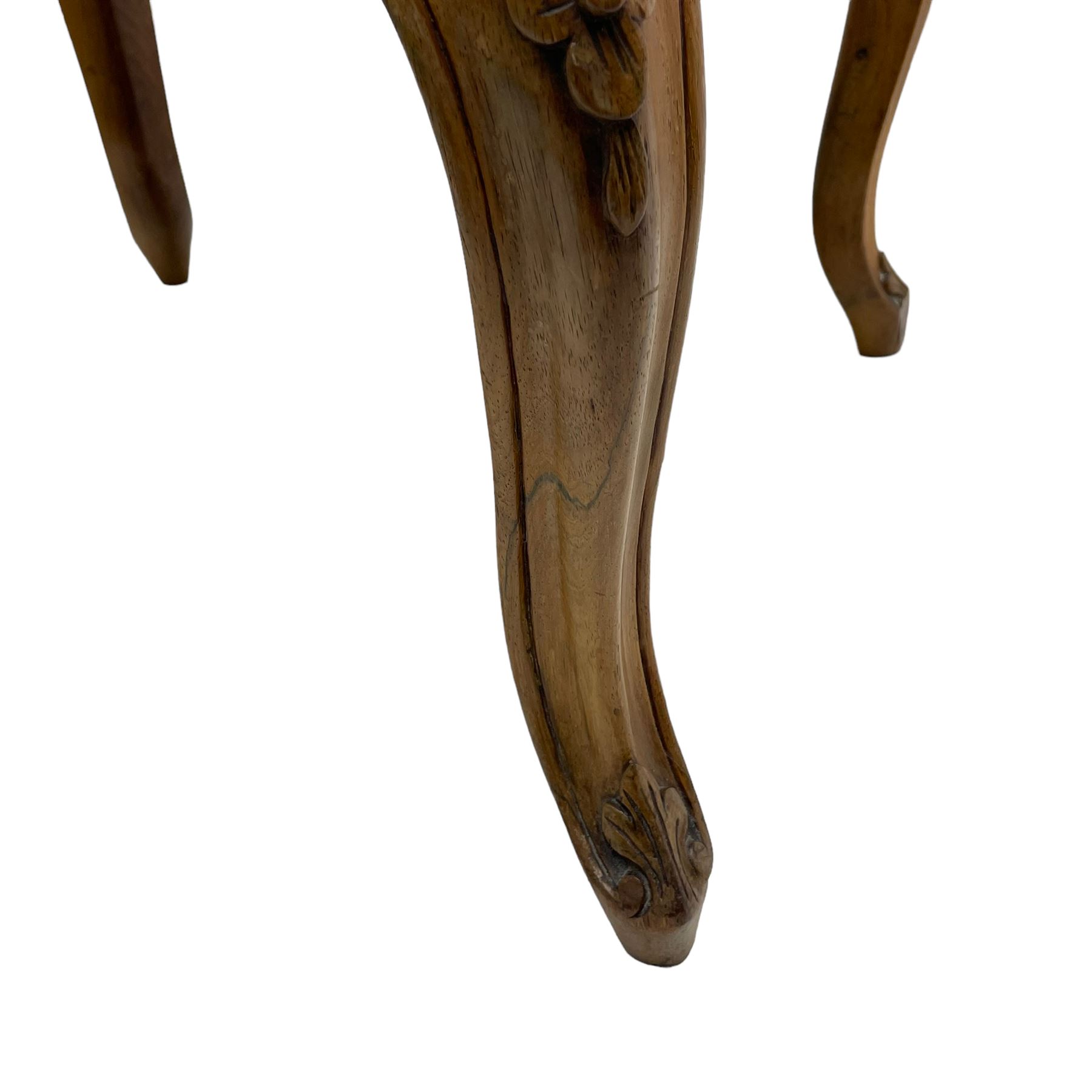 19th century French walnut dressing stool, rectangular seat upholstered in a floral needlework tapestry top, shaped apron with applied carved flower heads, on cabriole supports with acanthus carved feet