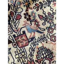 Persian Hamadan rug, ivory ground and decorated profusely with stylised plant, flower and bird motifs, triple band border decorated with stylised flower heads