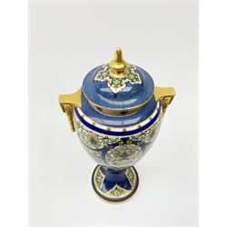An early 19th century Royal Worcester porcelain vase and cover, of baluster form with twin gilt handles, raised upon a spreading circular foot, decorated with Persian style foliate enamelled panels upon a blue ground, with puce printed marks beneath, rd no 669183, shape no 2713, H29cm.  