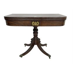 Regency mahogany tea table, rectangular fold-over top with rosewood banding and brass inlays, turned pedestal with four splayed supports carved with acanthus leaves, brass hairy paw cups and castors