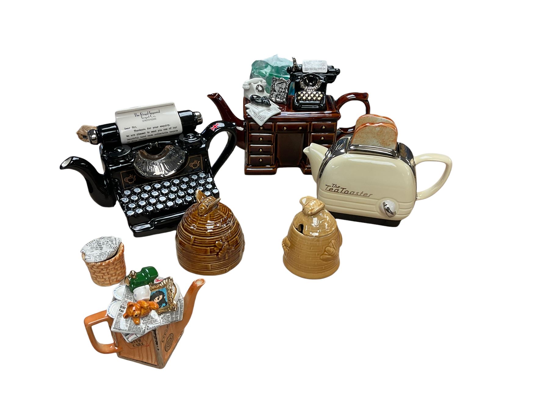 Collection of novelty teapots, together with two honey pots 