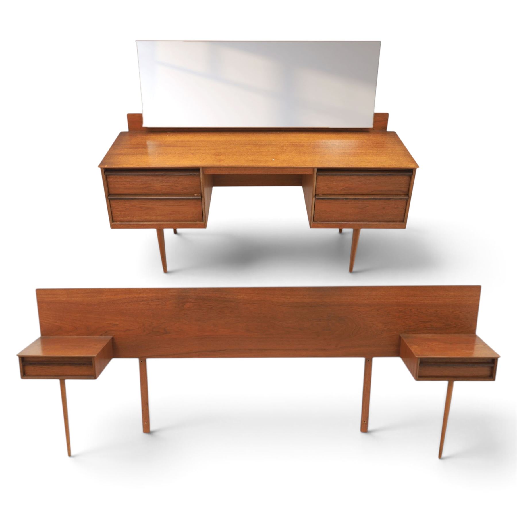 Austinsuite - mid 20th century teak headboard with bedside cabinets and matching  mirrored dressing table, the headboard with floating single drawer bedsides raised on a single tapering support, the dressing table with attached tilting mirror, above rectangular top with kneehole and two banks of two drawers, raised on tapering supports

Headboard H 84cm, D 40cm, W 229cm, W between bedsides 151cm 
Dressing table H 113cm D 44cm, W 149cm, H to underside of dresser 61cm