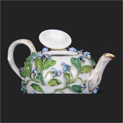 Late 19th century Meissen teapot, of ovoid form with gilt detailed 'crabstock' effect handle and spout, the body encrusted with forget-me-not flowers and leaves and painted with a single moth, with underglaze blue crossed swords mark beneath, H10cm