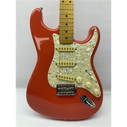 Japanese Squier Fender 'Hank Marvin' Stratocaster electric guitar, c1992, in Fiesta red with tremolo arm and facsimile signature decal; serial no.L037281, L98cm; in hard carrying case.
