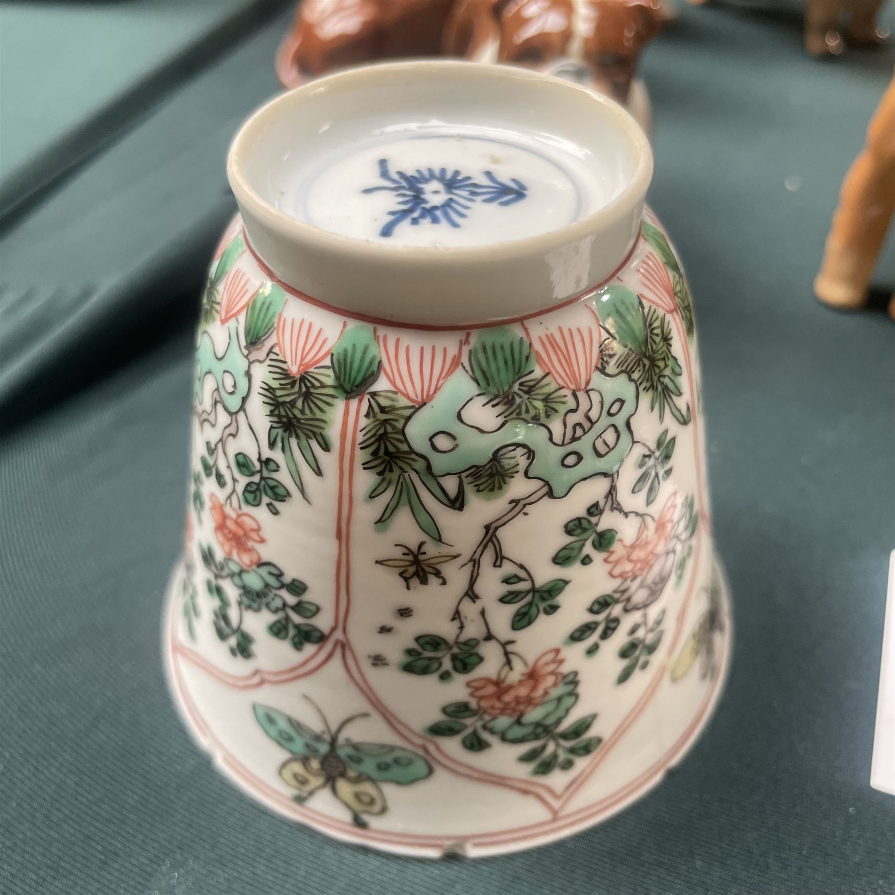 Three Chinese famille verte examples, approximately Yongzheng period, to include two teabowls and two saucers, each decorated with flowers and butterflies, two with sacred fungus mark within double rings, the teabowl with lotus mark, the other indistinct - possibly a Wan mark within lozenge (4)