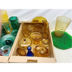 A large collection of glassware, comprising mostly amber glass, and some green and blue glass, to include various vases, bowls, drinking glasses, etc. 