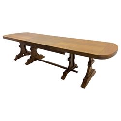 Oak extending dining table with elegant scrolled shaped double pedestal base and scrolled feet; together with a set of eight ladder back chairs with rush seats ((9) table closed 228x95x79cm chairs 106x38x44cm 