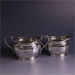 1930s silver four piece tea service, comprising teapot, hot water pot, sugar bowl and milk jug, each of part faceted oval form with engraved monogram to body, the teapot and hot water pot with Bakelite type handles and finials, hallmarked Atkin Brothers, Sheffield 1933