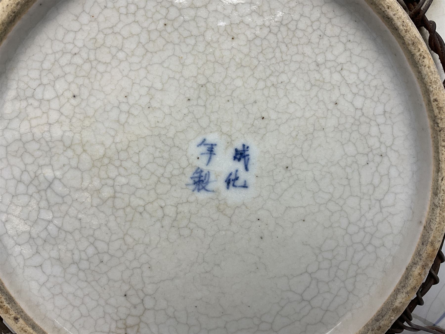 20th century Chinese blue and white crackle glaze charger, decorated with peonies, prunus blossom, and rockwork, within simulated bronze border, with character mark verso, D34cm