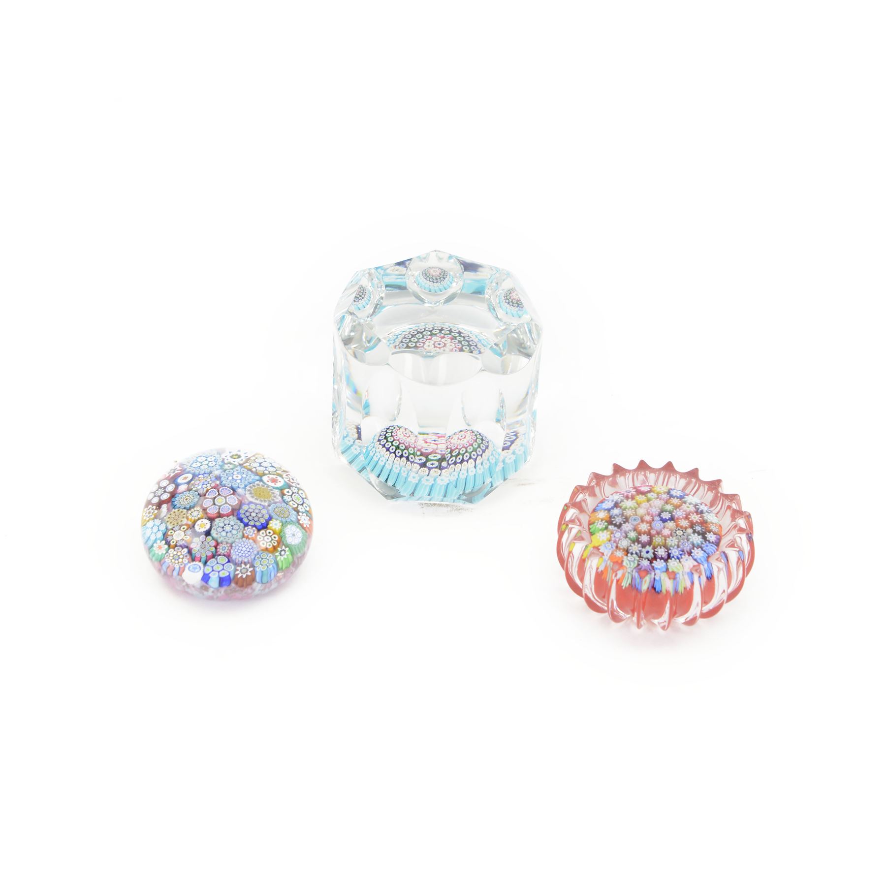 Two Peter Dougall glass paperweights, one of domed form, internally decorated with a  multicoloured millefiori canes, the other with fluted edge the with millefiori canes on a red ground, together with Whitfriars paperweight, all signed    