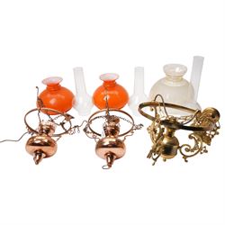 Pair of brass pendant light fittings with orange glass shades and another with partly fros...