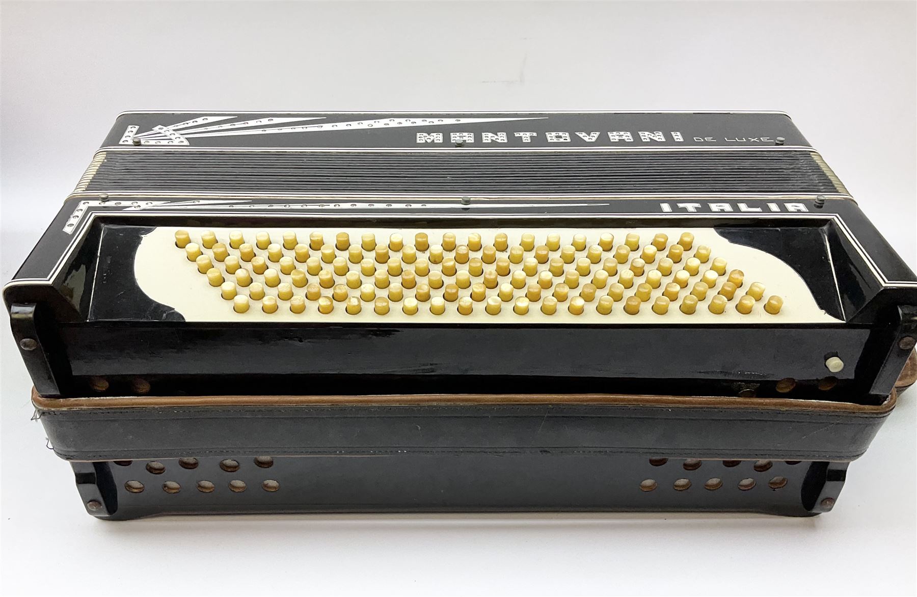 Italian Mantovani piano accordion with Art Deco style black and white case, twenty-four keys and one-hundred and twenty buttons L52cm in carrying case