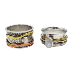 Two silver spinner rings set with a moonstone and an opal, stamped Sil  