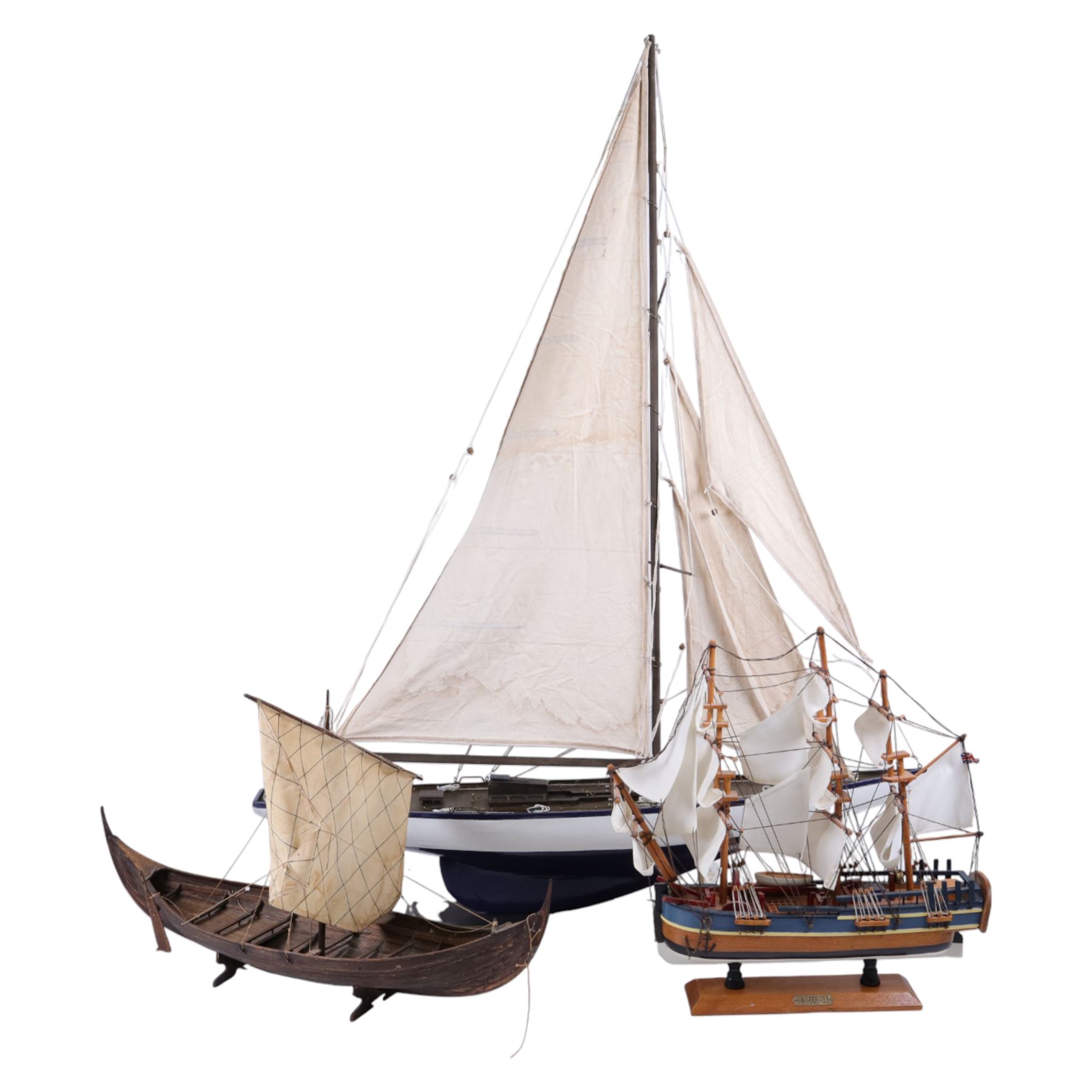 Three wooden model ships, comprising a single mast Schooner style pond yacht, a kit-built Viking longship and a model of HMS Endeavor, Schooner H117cm