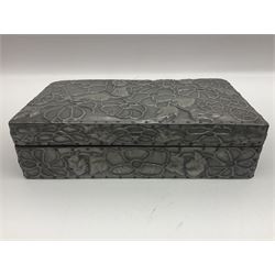 Liberty & Co Tudric pewter cigarette box, of plain rectangular form, with planished decoration to the slightly domed cover, opening to reveal a softwood interior, stamped Made in England 01234 Tudric Solkets beneath, together with another cigarette box, with applied pewter panels repousse decorated throughout with flower heads and leaves, with compartmentalised softwood interior, largest H5.5cm, W23cm
