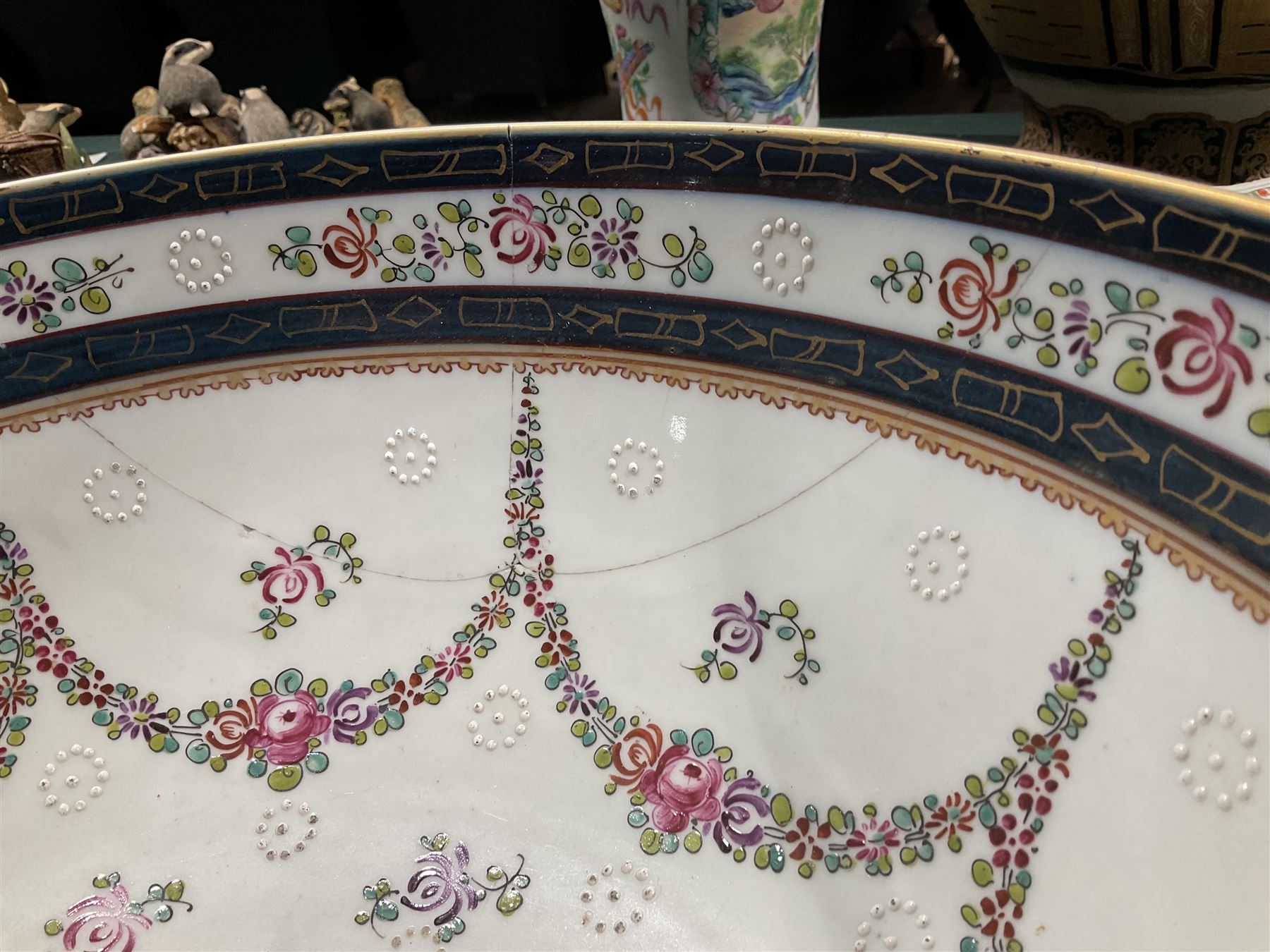 19th century Samson style punch bowl, decorated in the manner of a Chinese export example, with floral sprays and gilt highlighted cobalt blue double border to rim, with armorial crest to exterior, red mark beneath, D35cm