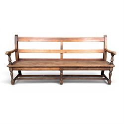 Early 20th century pine and oak bench seat, stained pine rail back frame with shaped oak arms