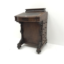  Victorian inlaid figured walnut davenport, hinged sloped top with leather inset, four drawers to right hand side, turned pilasters  with scroll carved terminals, on sledge platforms with turned feet and castors, W54cm, H85cm, D56cm  