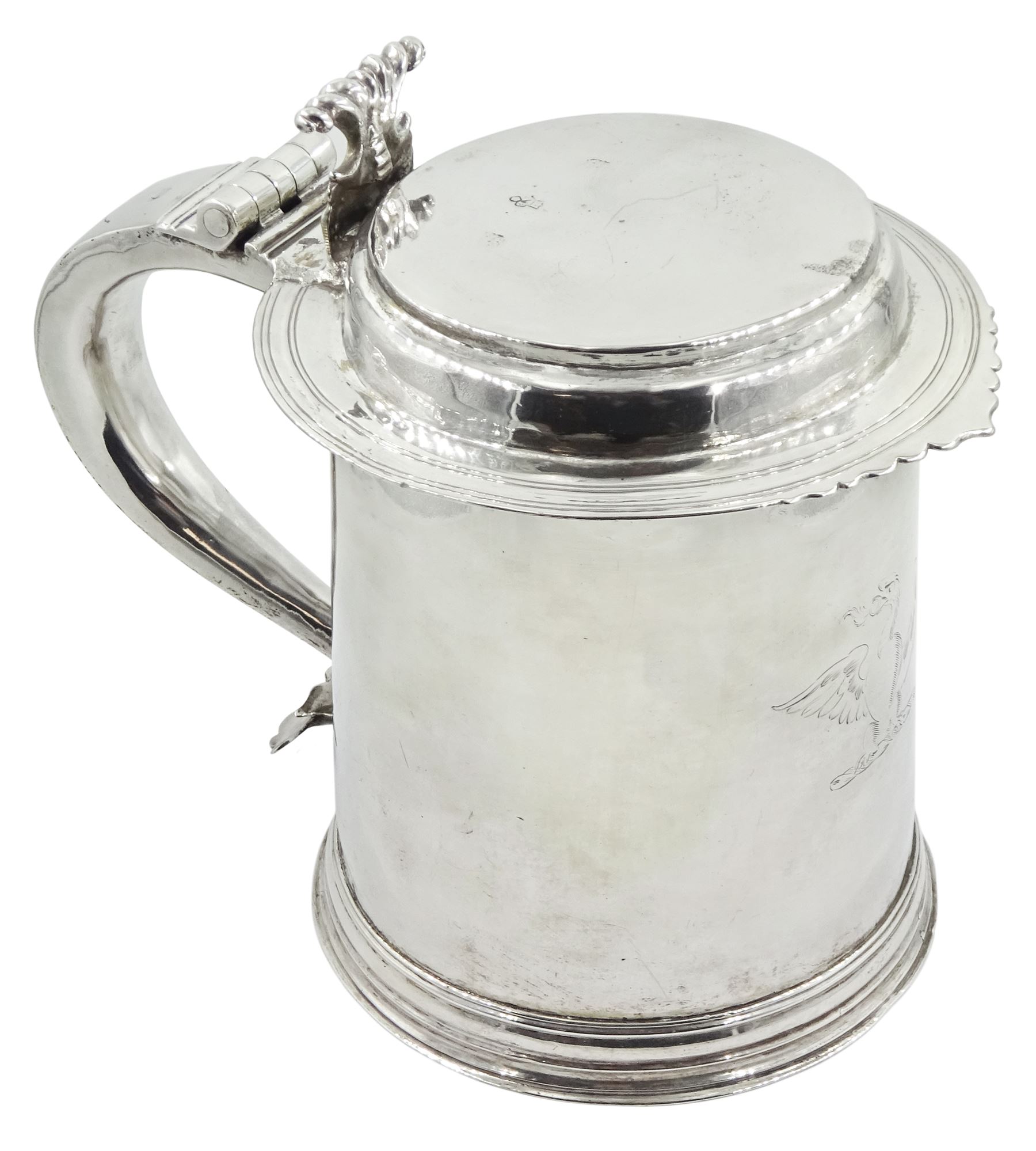 Queen Anne silver tankard, of plain tapering cylindrical form, with stepped and flat-domed cover, twit cast thumbpiece and curved handle, the body engraved with eagle crest, hallmarked Abraham Barachin, Hull, circa 1706, the body and cover stamped once with makers mark and twice with town mark, H18cm, approximate weight 21.46 ozt (667.7 grams)
