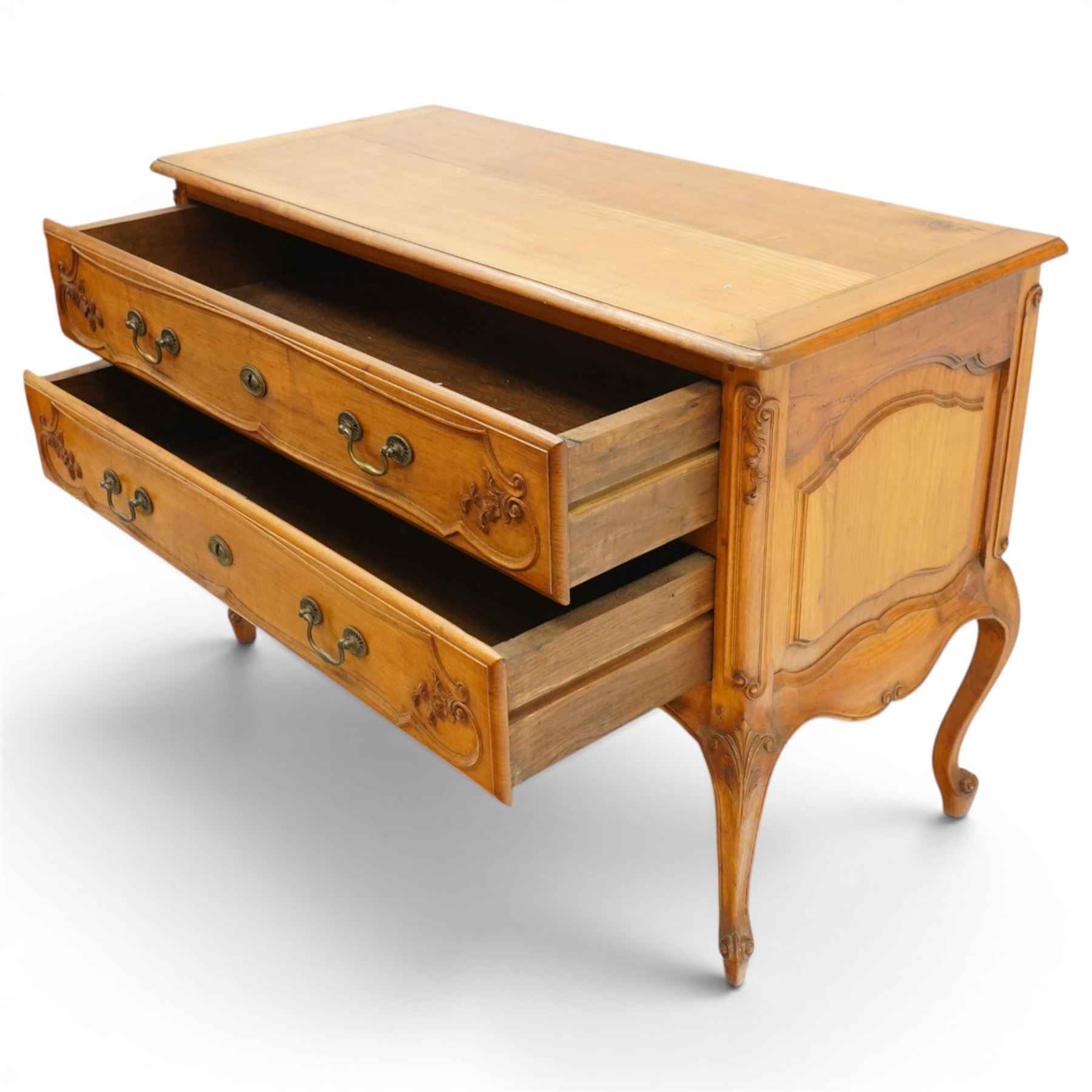 Early 20th century French fruitwood commode chest, rectangular top with moulded edge, fitted with two long drawers with moulded scroll and floral decoration, shaped apron with moulded scallop motif and trailing foliate, raised on cabriole legs with acanthus carved knees and scroll feet