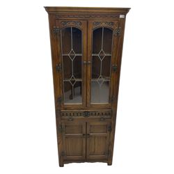Pair of Old Charm oak corner display cabinets, fitted with lead glazed doors