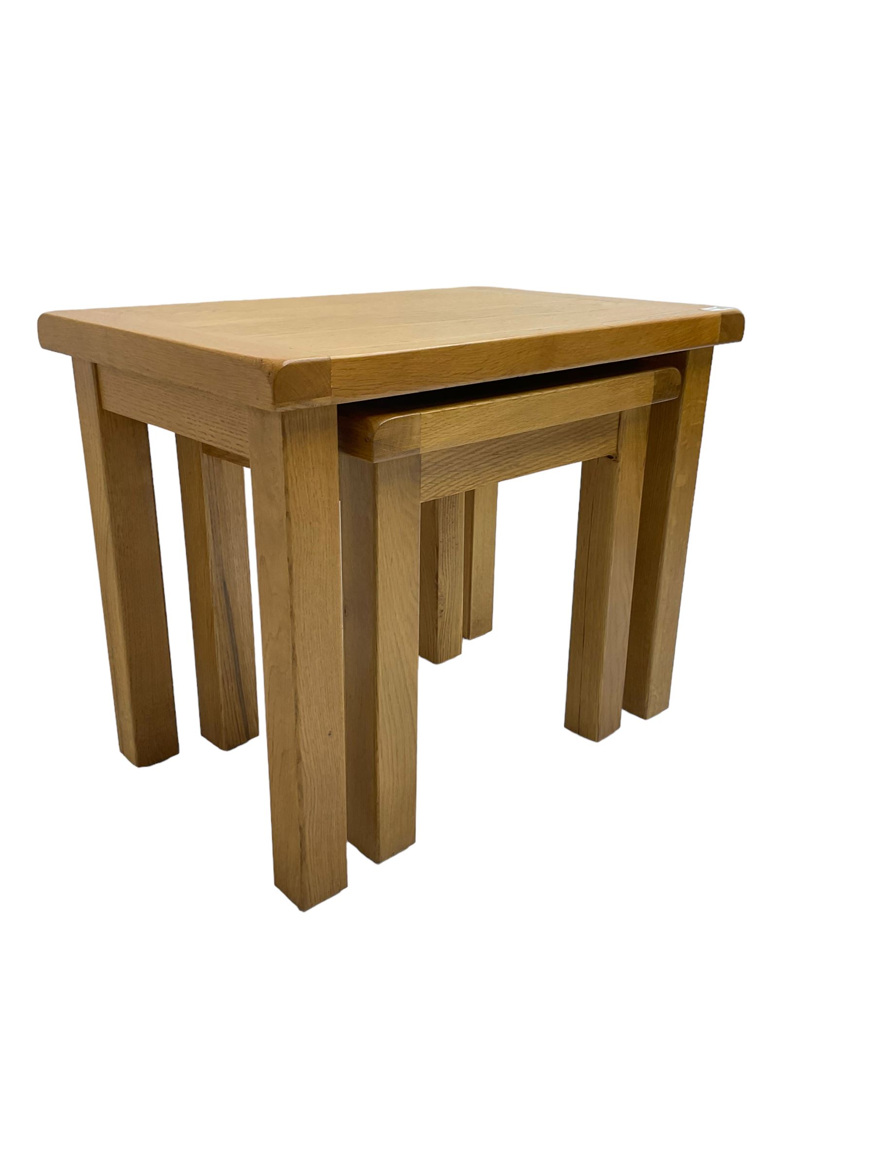 Light oak nest of two tables, rectangular top raised on square supports