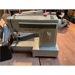 Two Singer sewing machines, model numbers 527 and 457, together with various Singer sewing machine parts, and a selection of sewing related accessories, to include threads, sewing needles, etc.