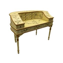 Oriental Carlton House style cream lacquered desk, decorated with floral motifs, fitted with eleven drawers and two cupboard doors, raised on turned legs with carved floral motifs