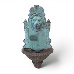 Antique cast iron wall fountain, cartouche cresting rail over a lion mask spout, with scro...