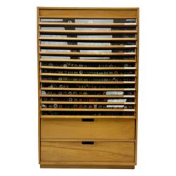 Large beech haberdashery thread storage cabinet, rectangular form with fourteen glass-fronted sloping drawers housing an extensive array of thread spools in assorted colours, over two larger drawers, raised on plinth base