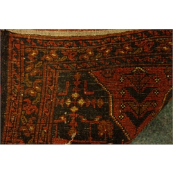  Afghan red ground rug decorated with Heretti and stylized motifs, 190cm x 133cm  