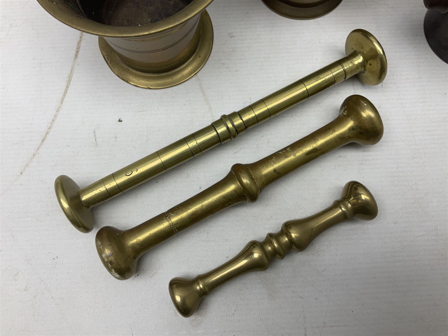 Group of pestle and mortars to include heavy bronze example with twin ...
