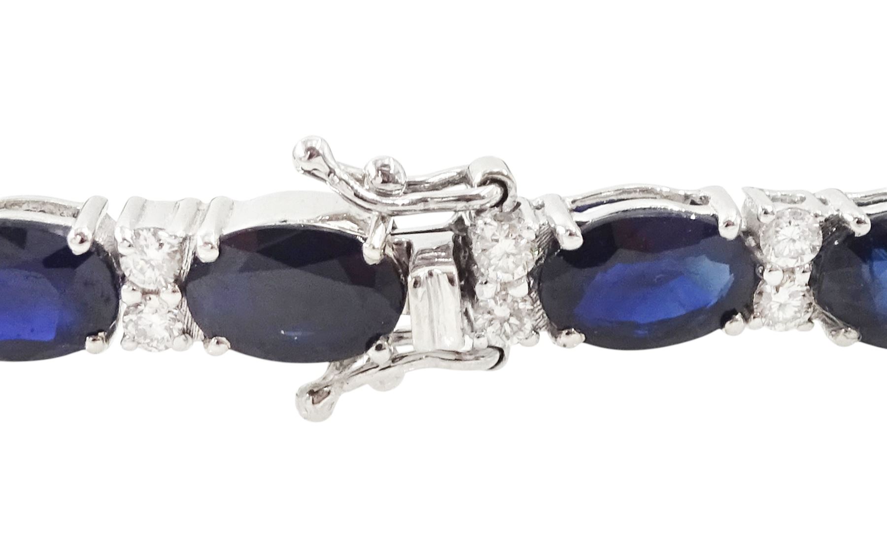 18ct white gold sapphire and diamond bracelet, twenty-three oval cut sapphires, each spaced by two round brilliant cut diamonds, stamped 750, total sapphire weight 14.785 carat, total diamond weight 0.88 carat