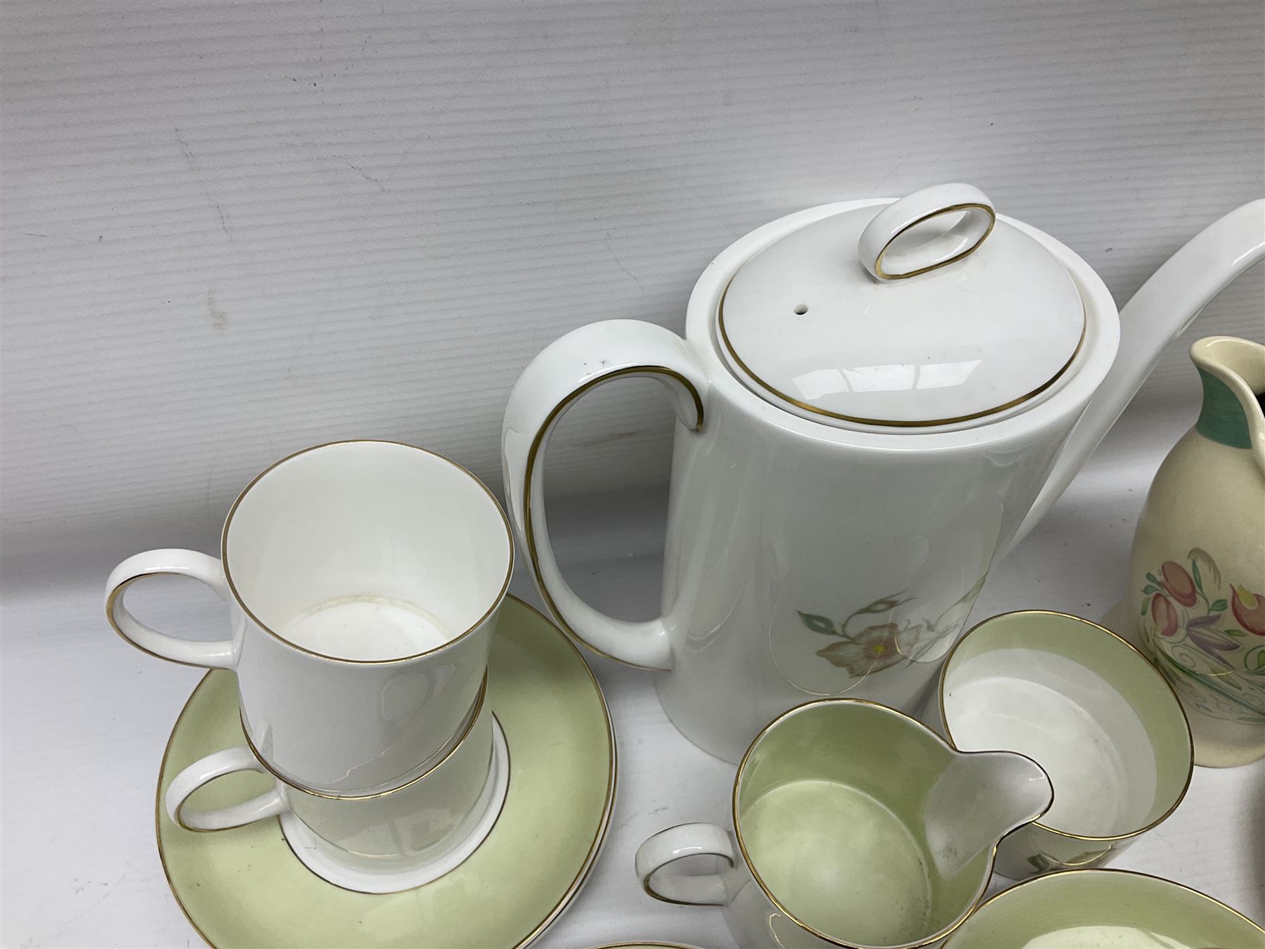 Susie Cooper Dresden Sprays pattern breakfast set, including coffee pot, sugar bowl, milk jug, egg cup, teacup trio and bowl, together with a Susie Cooper Wild Rose pattern coffee service for six