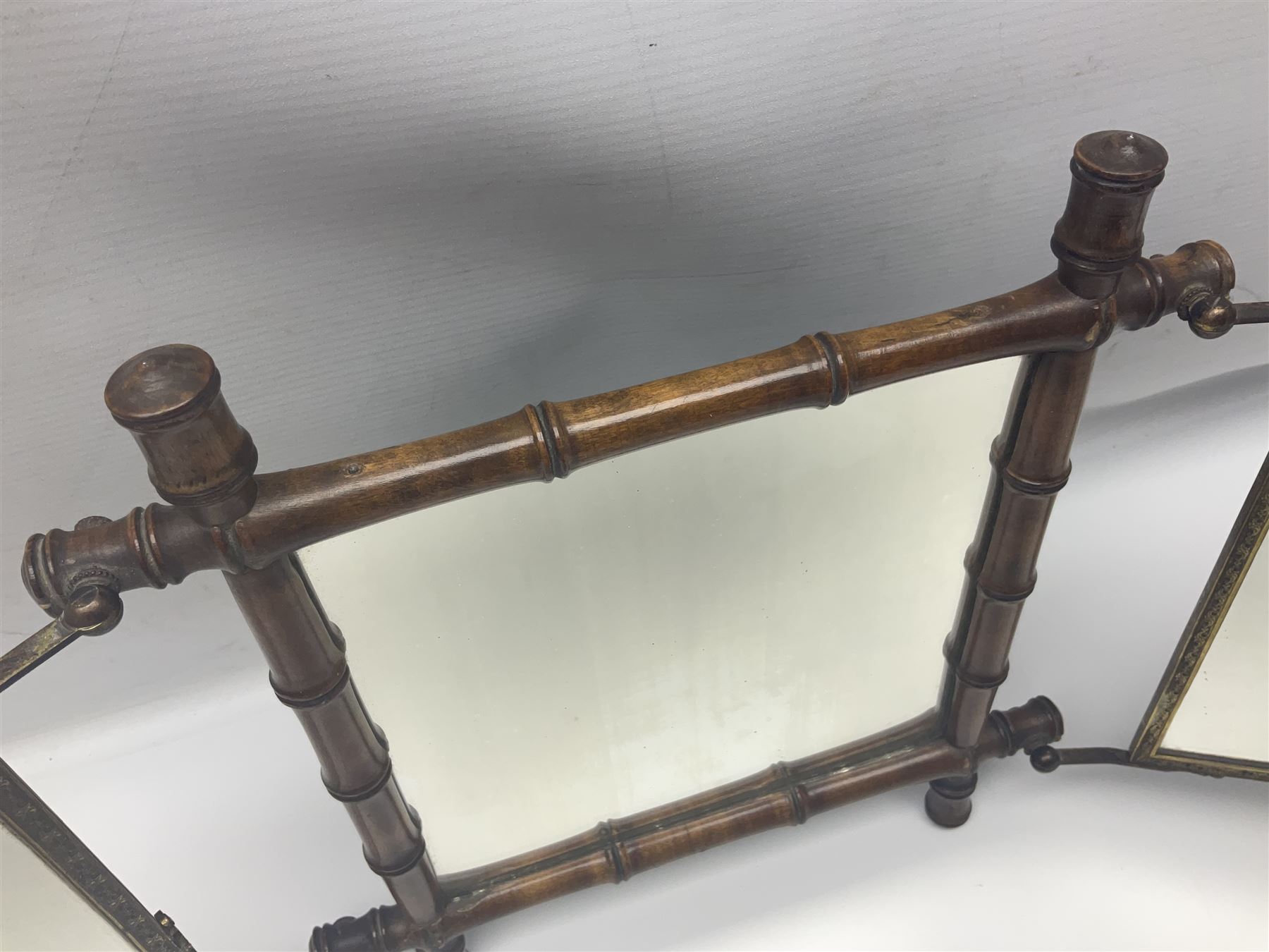 Japaneses triptych mirror, with two fold out panels with prints depicting egrets and figures in a garden with Japanese text, within a bamboo frame, H32cm