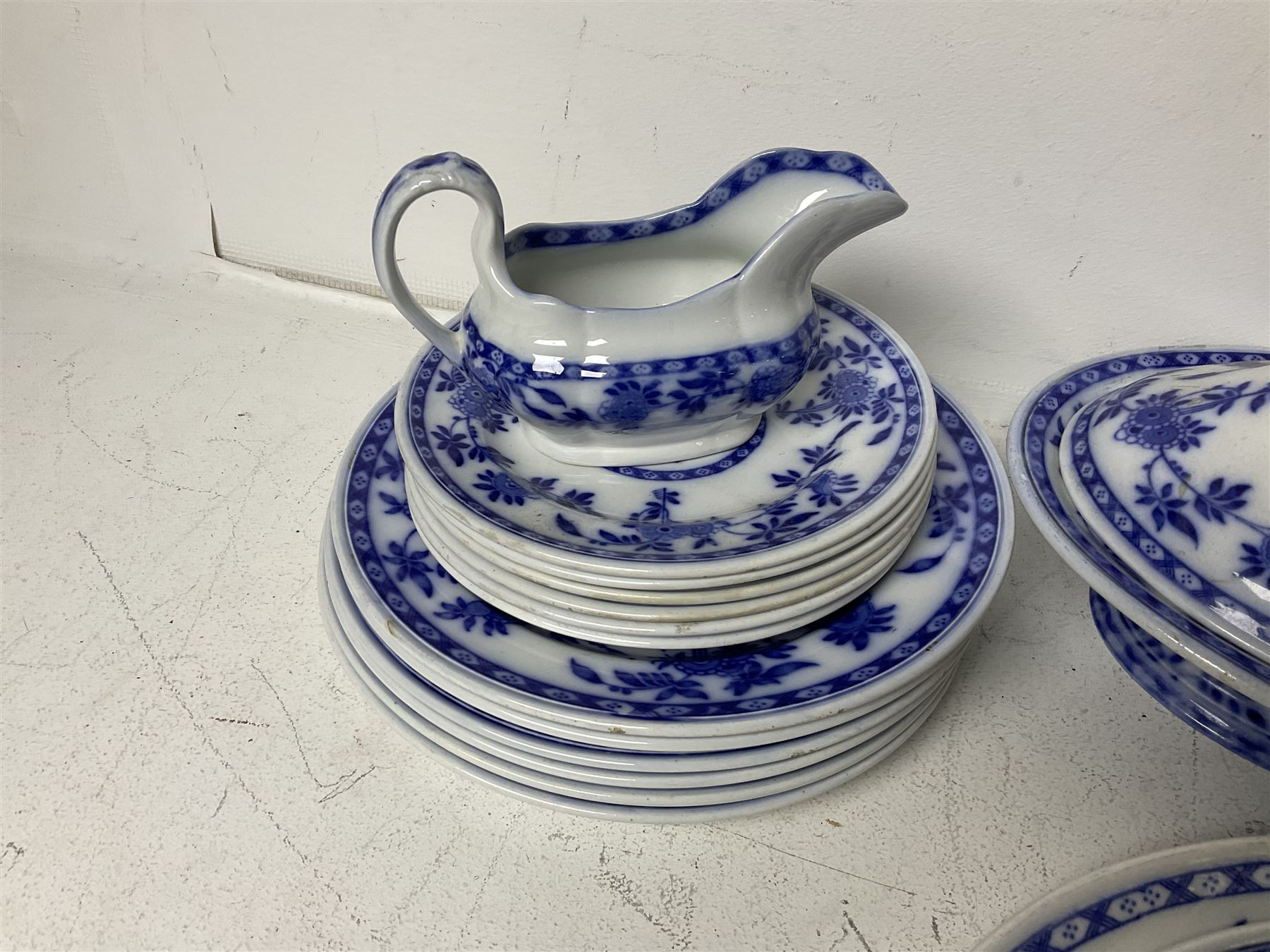 Mintons Delft blue and white dinner wares, to include three graduating oval platters, six dinner plates, six dessert plates and six side plates, tureen with cover and two sauce boats