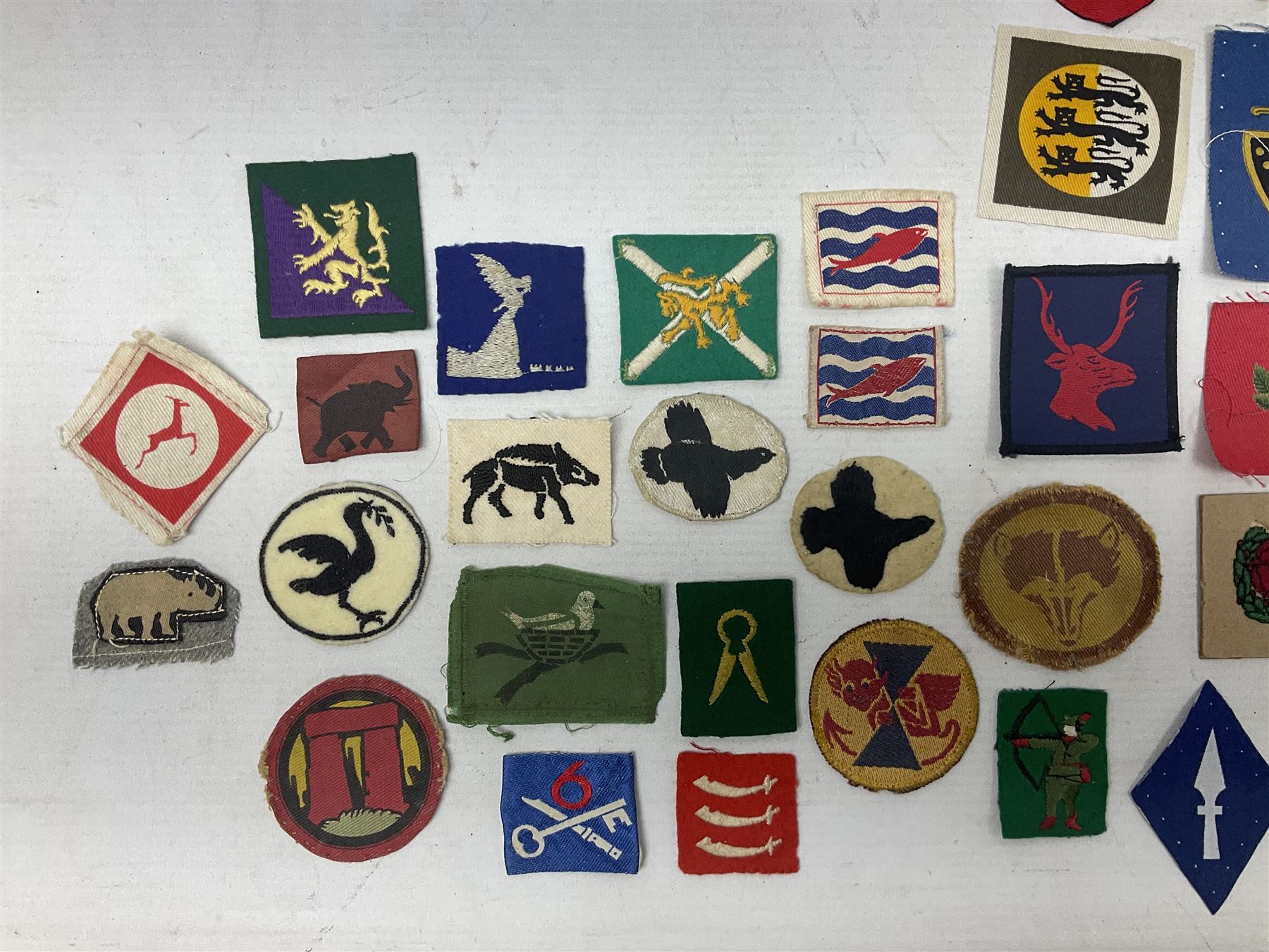 Approximately one-hundred printed and embroidered cloth badges including I, II, VIII, XI, XII and XXX Corps, Eastern Command, various Armoured Divisions, Midland, Wessex, Home Counties and 12th Infantry Brigades, Salisbury Plain, Northumberland, Hampshire, North Midland, West Riding, Essex and Suffolk Districts, Berlin & Rhine Army Troops etc