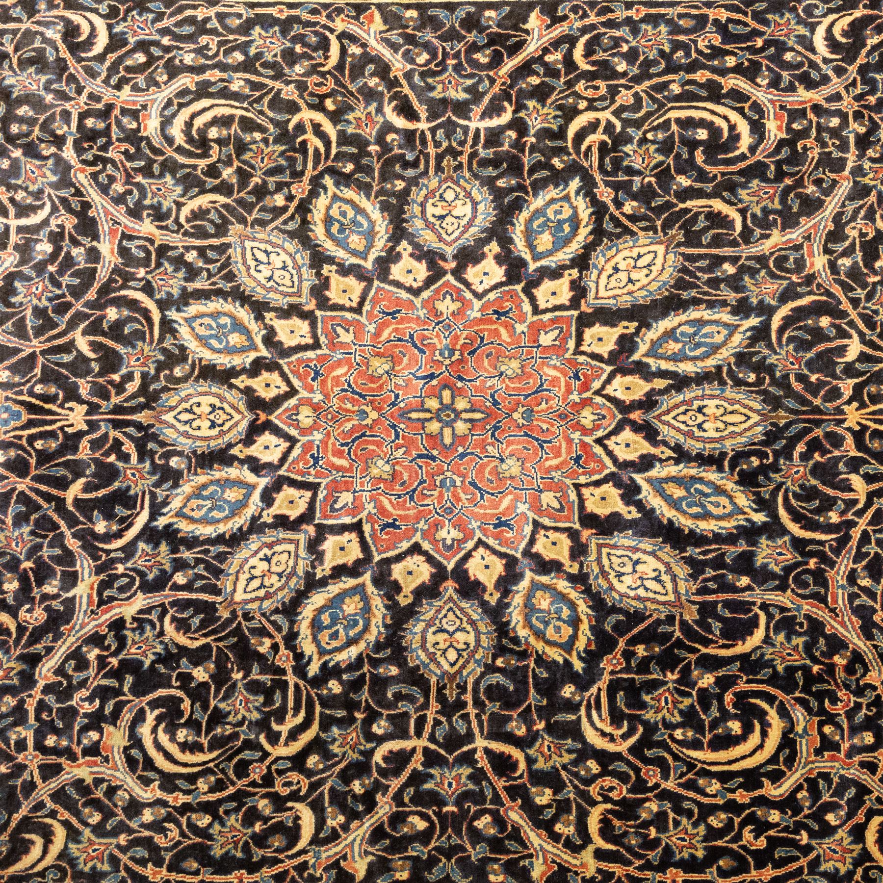 Large North West Persian Mahal hand-knotted carpet, central indigo field with a rosette medallion with an all-over design of scrolling vines and palmettes, framed by a brick red border of arabesques and flowerheads between sky blue and ivory guard stripes, with cotton fringe ends 