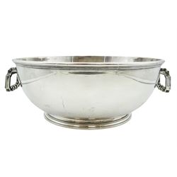 Mid 20th century German silver footed bowl, the body of plain circular form with twin articulated cast handles, marked with crown and crescent mark, and stamped 925 beneath, also bearing import marks for London Assay Office, London 1945, H10cm not including handles D25cm, approximate weight 44.62 ozt (1388 grams)