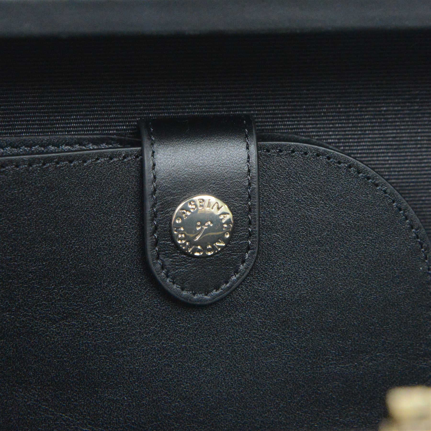 Aspinal of London black leather structured top-handle handbag with gold-tone metal mounts and corner protectors, the hinged lid opening to a fabric-lined interior fitted with a zip pocket and slip compartment, leather brand label stamped Aspinal of London England, fitted with a detachable adjustable leather shoulder strap, accompanied by an Aspinal of London dust bag and presentation box, W19cm D8cm H16cm